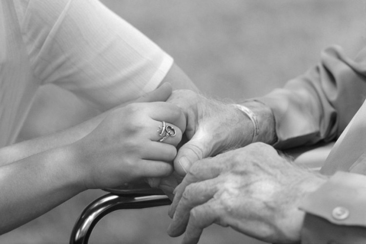 And old and young person holding hands